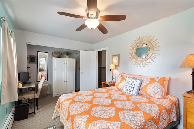 carpeted bedroom featuring a baseboard radiator and ceiling fan