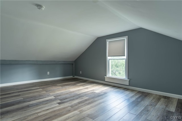 bonus room featuring vaulted ceiling and hardwood / wood-style floors