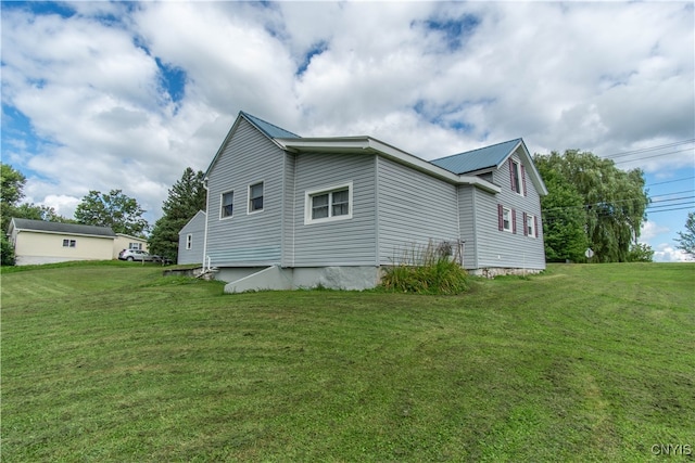 view of side of home featuring a yard