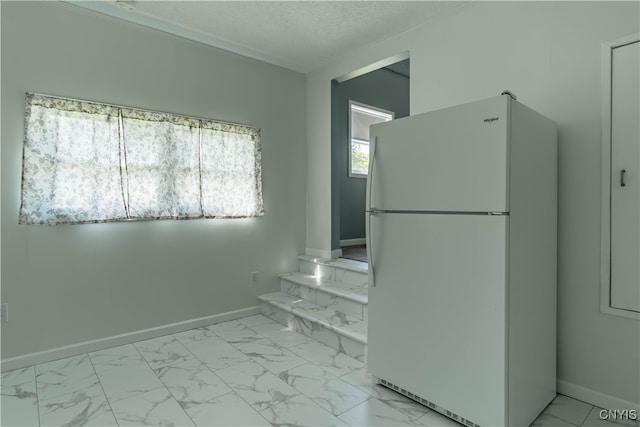 interior space with tile patterned flooring and a textured ceiling