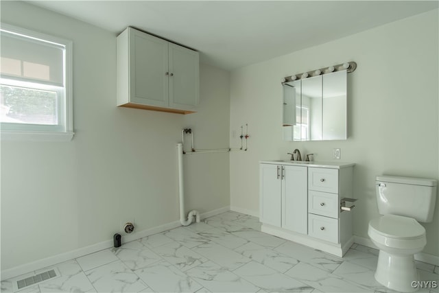 clothes washing area featuring sink and light tile patterned floors