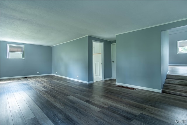 empty room with crown molding and wood-type flooring