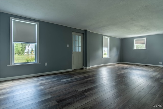 spare room with a textured ceiling and wood-type flooring