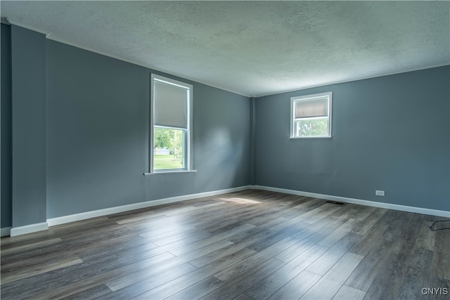 empty room featuring a textured ceiling and wood-type flooring