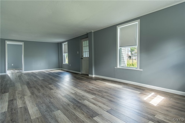 unfurnished room with hardwood / wood-style flooring