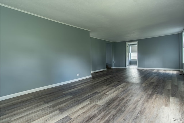 empty room with hardwood / wood-style flooring and crown molding