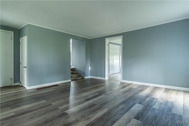 spare room featuring hardwood / wood-style floors and crown molding