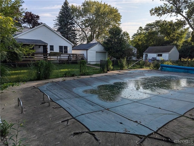view of pool featuring fence and an outdoor structure