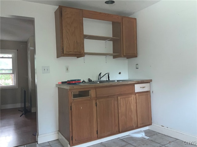 kitchen featuring sink and light tile patterned floors