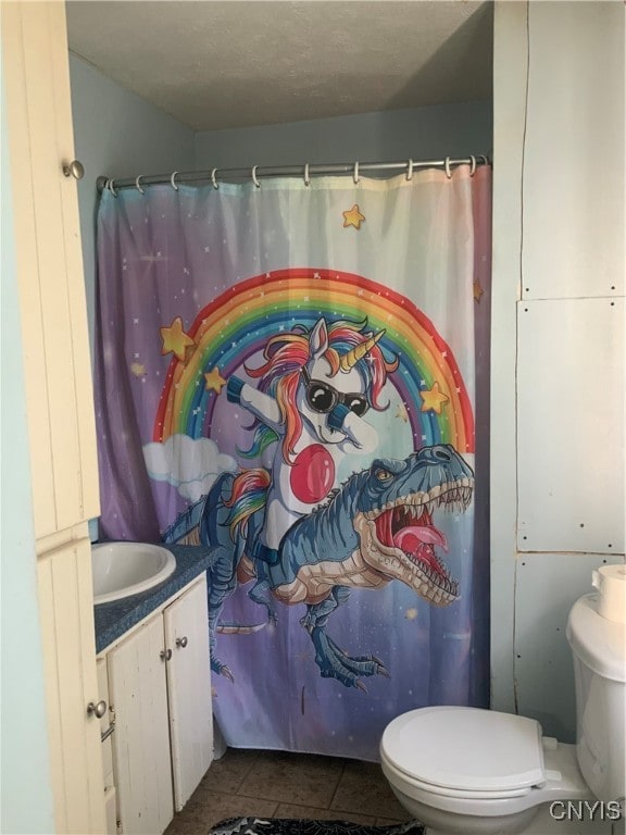 bathroom with tile patterned floors, vanity, and toilet