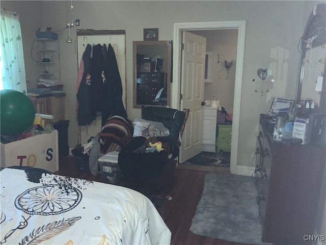 bedroom with wood-type flooring and a closet