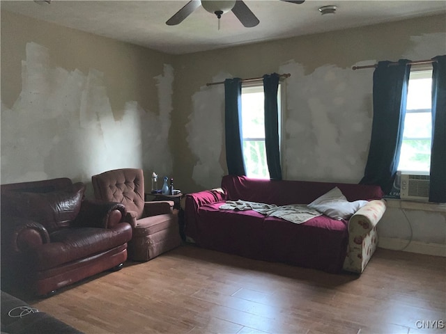 living room with ceiling fan, light hardwood / wood-style flooring, and cooling unit