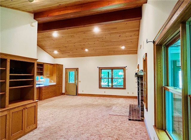 unfurnished living room with light carpet, wood ceiling, and high vaulted ceiling