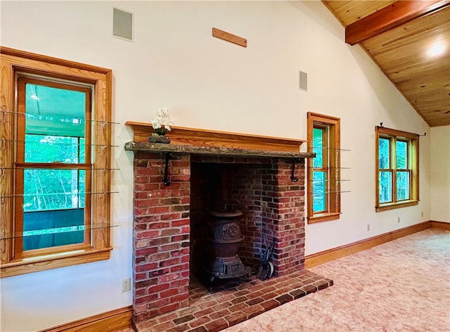 unfurnished living room featuring vaulted ceiling with beams, carpet floors, and wood ceiling