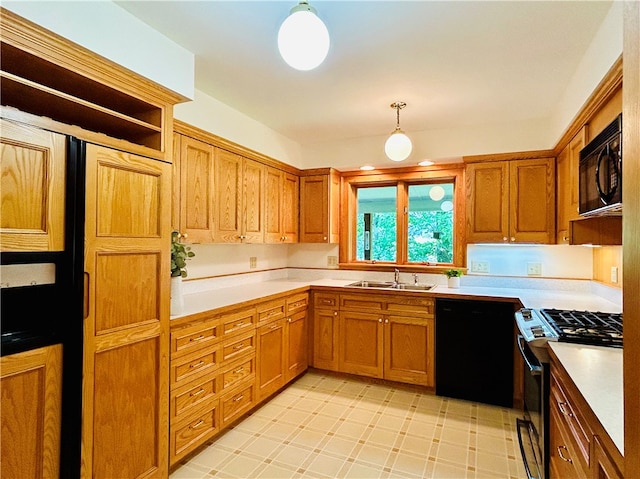 kitchen featuring pendant lighting, sink, and black appliances