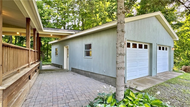 view of side of home featuring an outbuilding and a garage