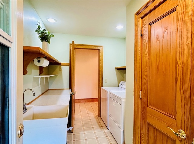 washroom with sink and washing machine and clothes dryer