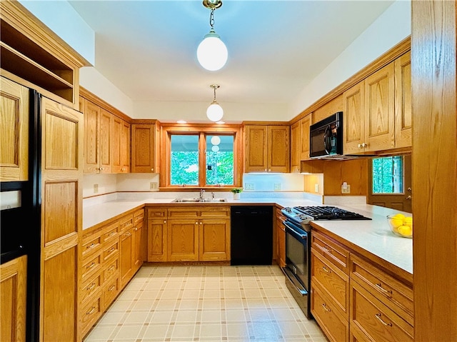 kitchen featuring hanging light fixtures, black appliances, and sink