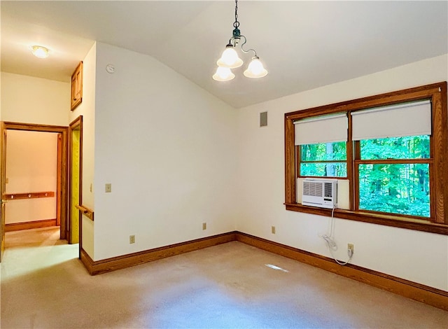 carpeted spare room with cooling unit, vaulted ceiling, and an inviting chandelier