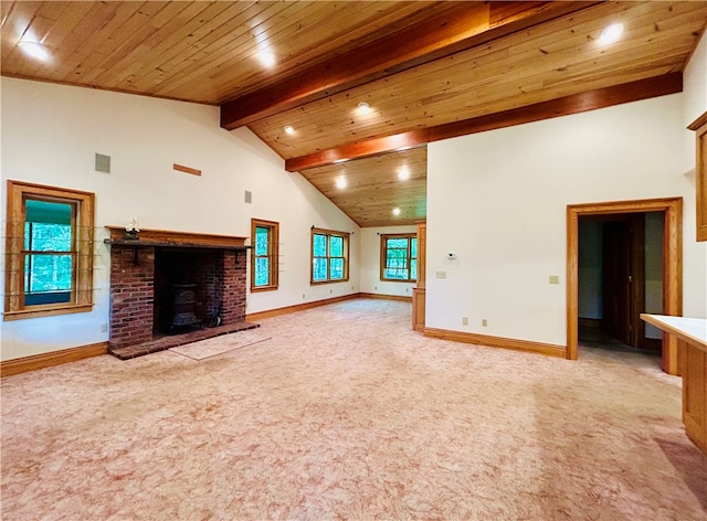 unfurnished living room with vaulted ceiling with beams, light colored carpet, wooden ceiling, and a healthy amount of sunlight