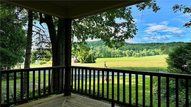 wooden deck featuring a lawn