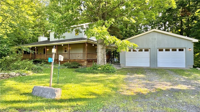 view of front facade featuring a garage, a front yard, and covered porch