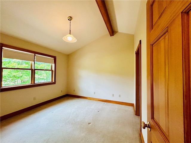 carpeted empty room with lofted ceiling with beams