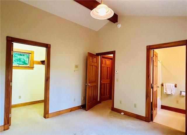 unfurnished bedroom featuring ceiling fan, light colored carpet, vaulted ceiling, and a spacious closet