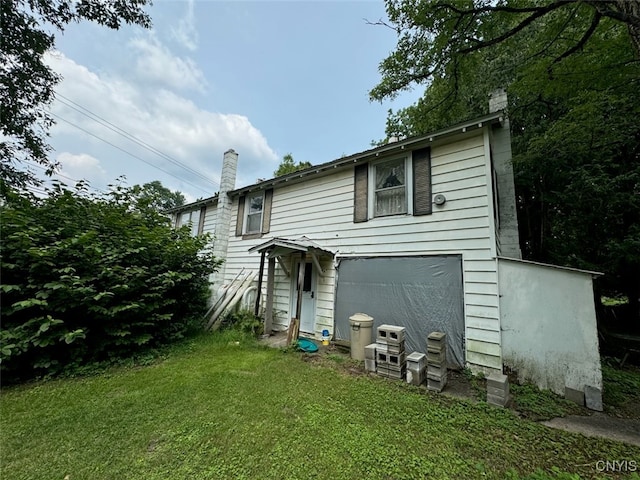 rear view of house with a lawn