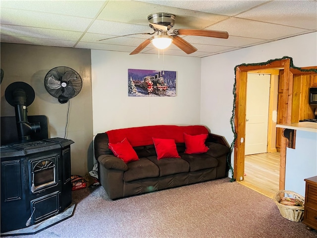 carpeted living room featuring ceiling fan and a paneled ceiling