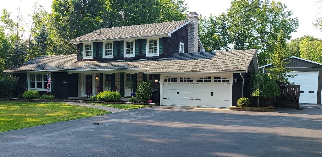 view of front of house with a garage and a front lawn