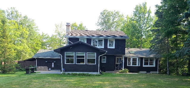 rear view of house with a yard