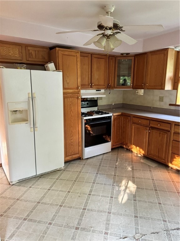 kitchen with ceiling fan, light tile patterned floors, tasteful backsplash, and white appliances