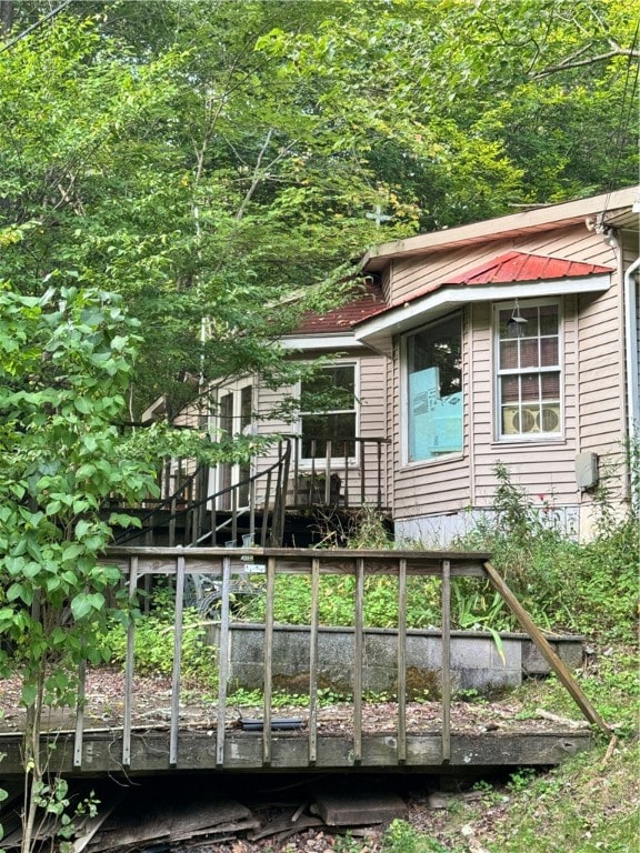 back of property with a wooden deck