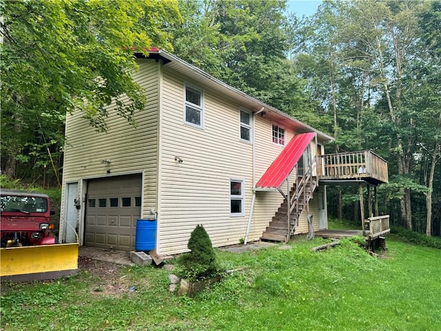1356 Terry Clove Rd, Hamden, NY 13752 - back of property featuring stairs, an attached garage, a deck, a lawn, and driveway