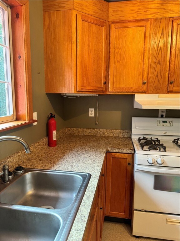 kitchen featuring sink and white gas stove