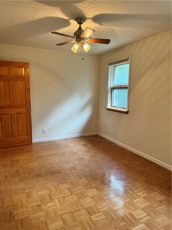 empty room featuring ceiling fan and light parquet flooring