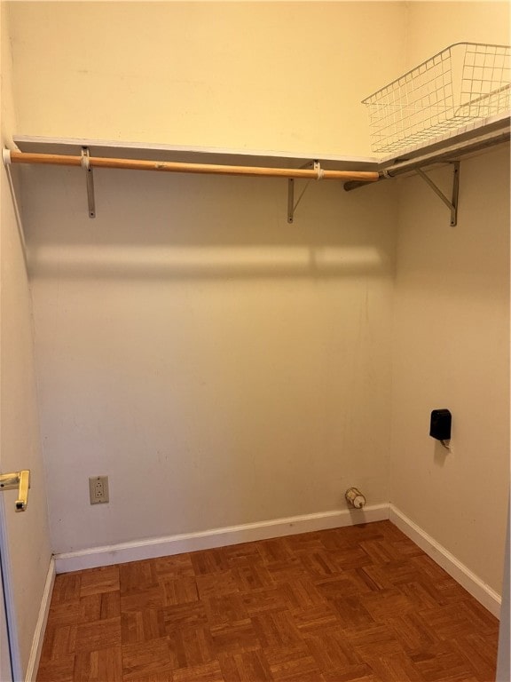 laundry room with hookup for an electric dryer and dark parquet floors