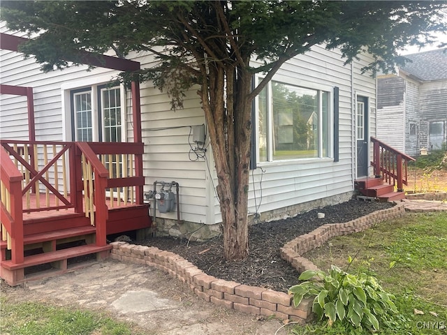 view of side of property with a wooden deck