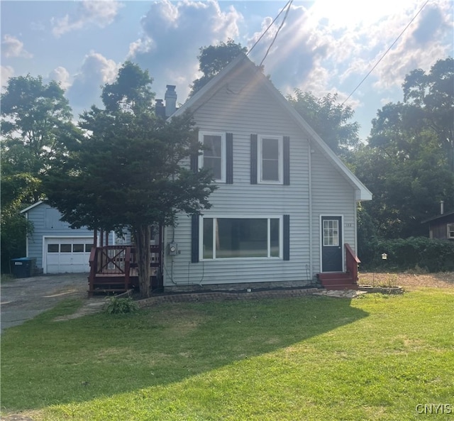 view of front of property with an outbuilding, a front lawn, and a garage