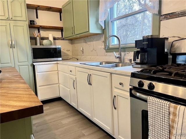 132 E Remington St, Rutland, NY 13612 - kitchen featuring appliances with stainless steel finishes, a sink, open shelves, wood counters, and decorative backsplash