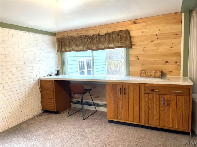 office area with light colored carpet and brick wall