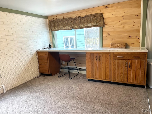 office area with light colored carpet and brick wall