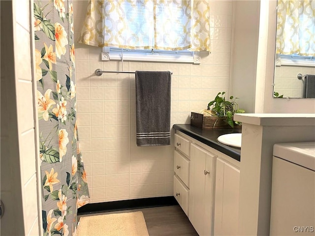 132 E Remington St, Rutland, NY 13612 - bathroom featuring vanity, tile walls, a shower with curtain, wood finished floors, and healthy amount of natural light