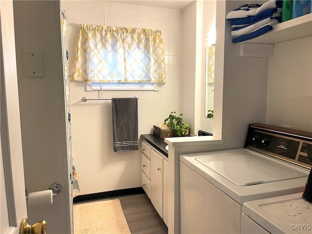 laundry area featuring washer and dryer and dark hardwood / wood-style floors