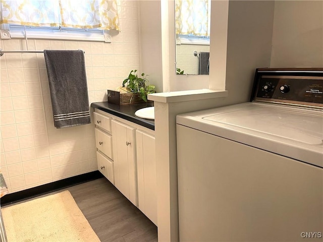 132 E Remington St, Rutland, NY 13612 - bathroom with washer / dryer, vanity, and wood finished floors