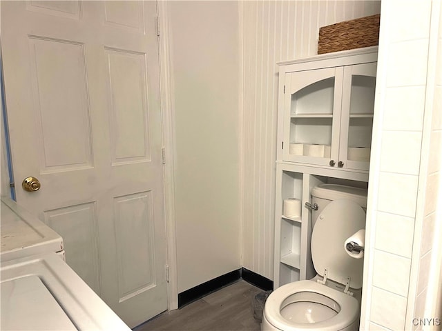 bathroom featuring wood-type flooring and toilet