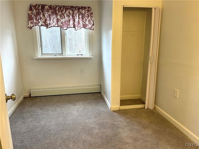 unfurnished bedroom featuring carpet flooring and baseboard heating