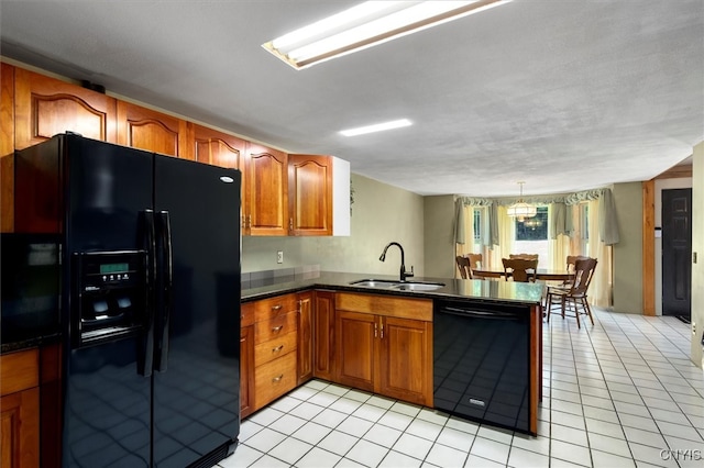 kitchen featuring light tile patterned floors, sink, kitchen peninsula, and black appliances