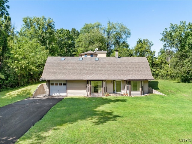 single story home with covered porch, a garage, and a front yard